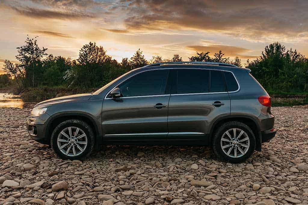 A customer's Volkswagen SUV parked next to a lake.